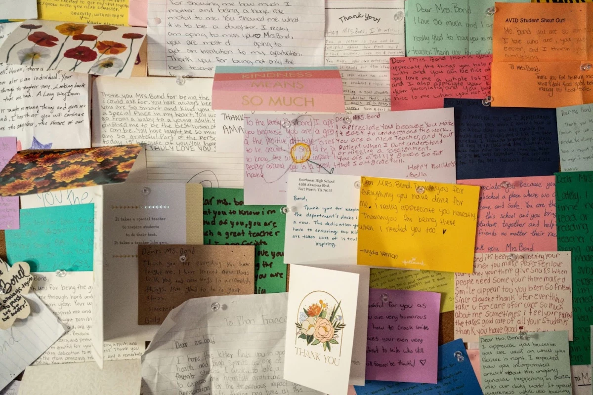 Bond's classroom includes a display of handwritten thank you notes from students.