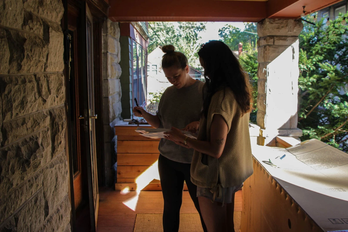 Leann Villaluz (right) has been going door to door for weeks to collect signatures for a petition to put Missouri's new congressional map to voters. She says most people she's talked to are willing to sign.