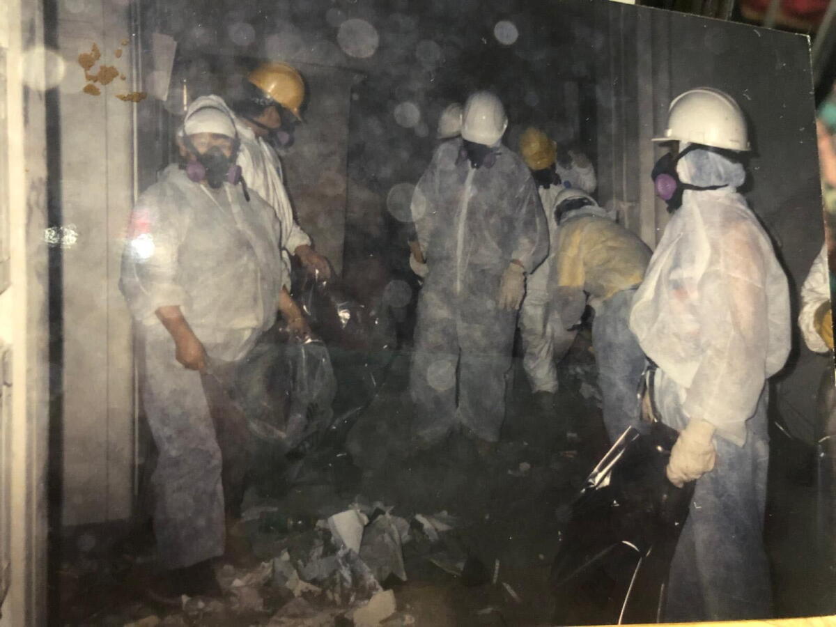A photo provided by a member of a Sept. 11 cleanup crew support group in Queens, New York, shows a group of workers at the ground zero site in the immediate aftermath of the Sept. 11 attacks.