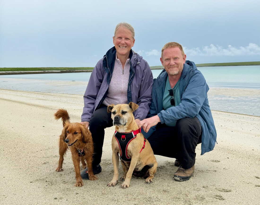 Susan Chinnery and Steve Lewis with their dogs Connie and Truffle on the Isle on the island of Westray in Orkney.