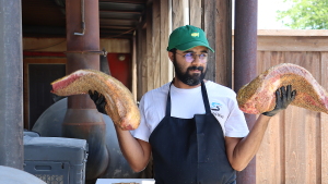 Zain Shafi prepares to put briskets in the smoker at Goldee’s BBQ in Fort Worth, Texas.