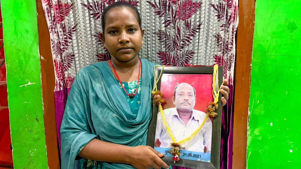 Jyoti Kumari holds a photo of her dad, Mohan Paswan. She became a global celebrity after news spread of her 700-mile bicycle ride, carrying her injured father on her bicycle, to get him to their village. Promises were made to reward her heroic feat. Were they kept?