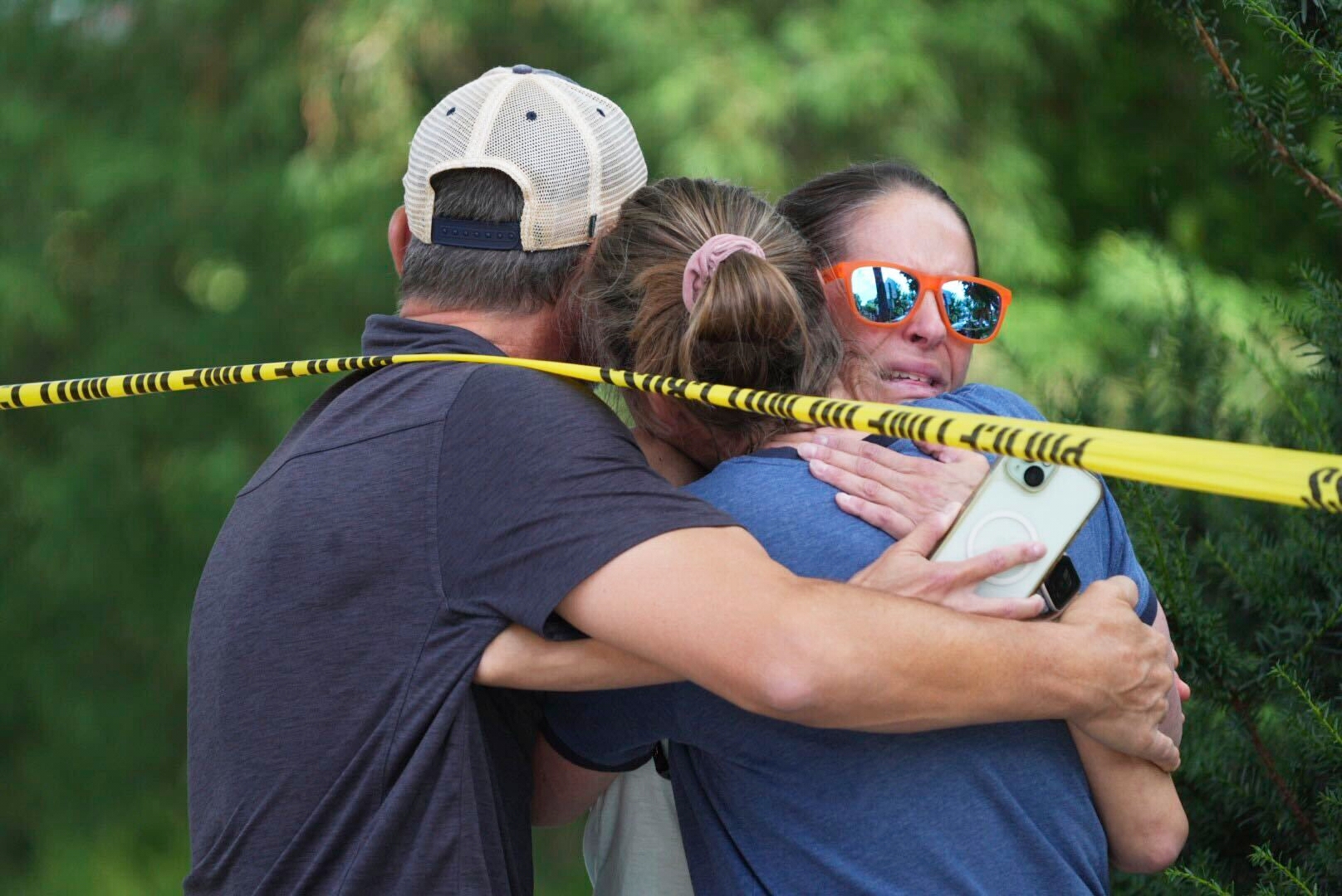 Community members embrace after a shooting at the Annunciation Catholic School on Wednesday in Minneapolis. (Star Tribune via AP)