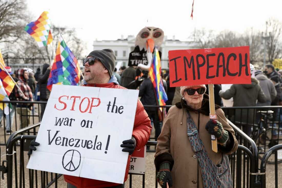 People protest outside the White House in Washington, D.C. after the U.S. strikes in Venezuela. Ken Kuchda of Alexandria, Va., left, and Lydia Riley of Washington D.C. attended the protest that was organized by the Party for Socialism and Liberation.