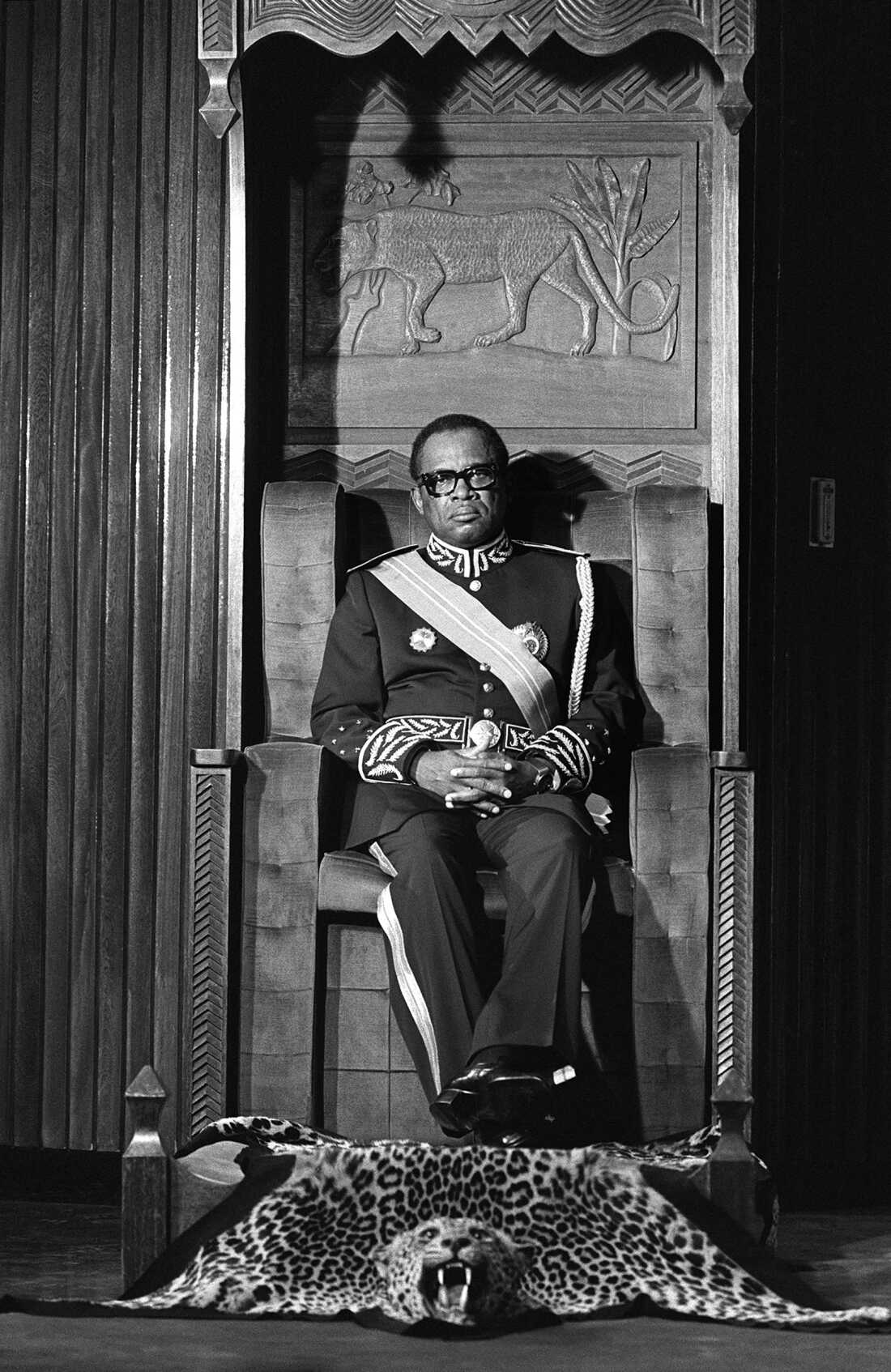 Mobutu Sese Seko, president of Zaire (now the Democratic Republic of the Congo), sitting on a throne with feet resting on a tiger skin, takes oath on December 05, 1984 in Kinshasa.