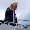 President Donald Trump waves as he boards Air Force One, Sunday, March 29, 2026, at Palm Beach International Airport in West Palm Beach, Fla.
