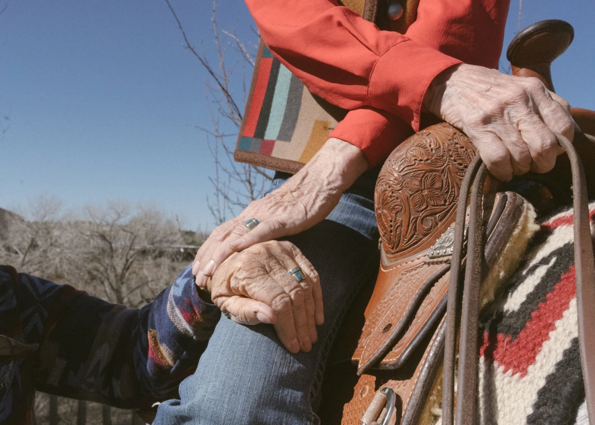 Terry sits on her horse while holding Helen's hand in the backyard of their home in Santa Fe, N.M.