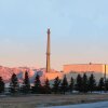 The Advanced Test Reactor at Idaho National Laboratory with trees in the foreground and mountains behind it.