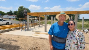 Scott and Juliet Welden in front of the construction of their new home in Kerrville.