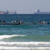 Fishermen work in front of oil tankers south of the Strait of Hormuz on Jan. 19, 2012, offshore of the town of Ras Al Khaimah in United Arab Emirates.