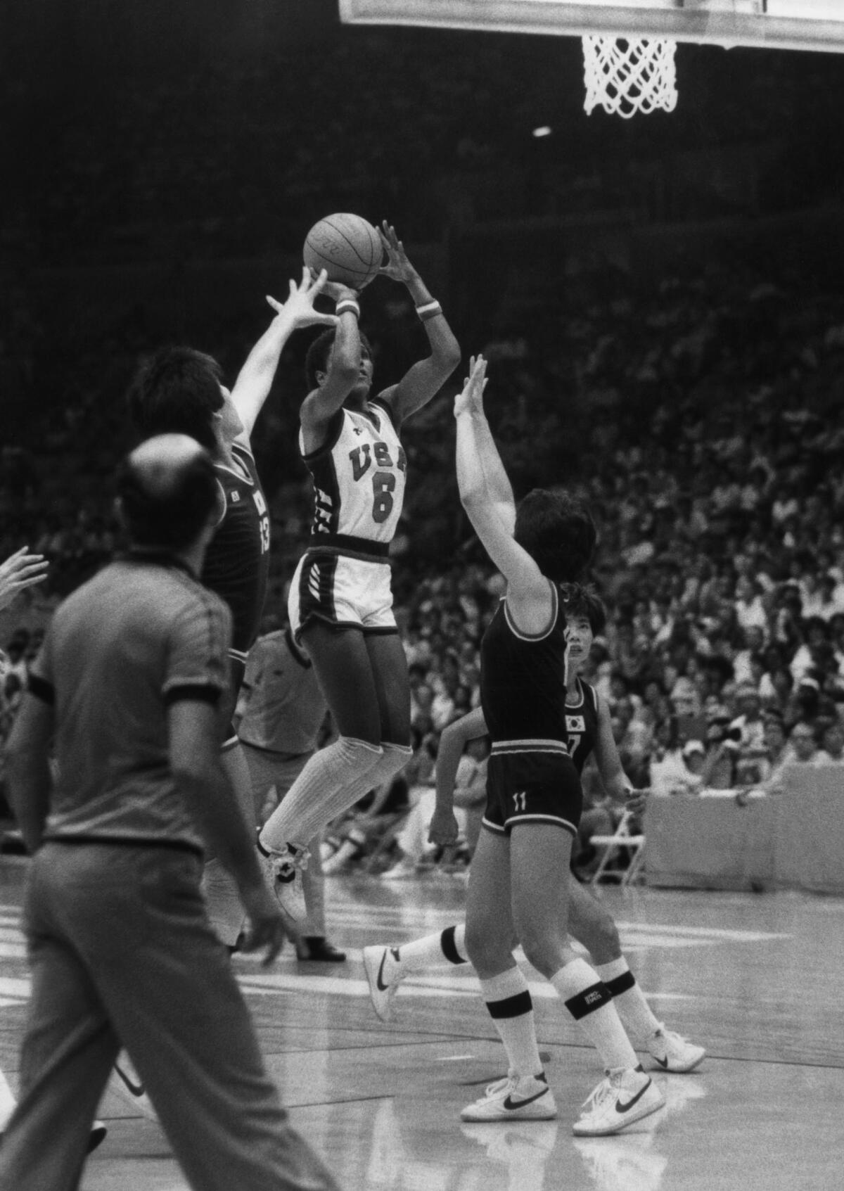 Lynette Woodard of Team USA eludes Korean players to score during the 1984 Summer Olympics women's basketball final on July 8, 1984 at the Forum in Los Angeles. Her 10.5 points per game was second-highest on the team behind Cheryl Miller.