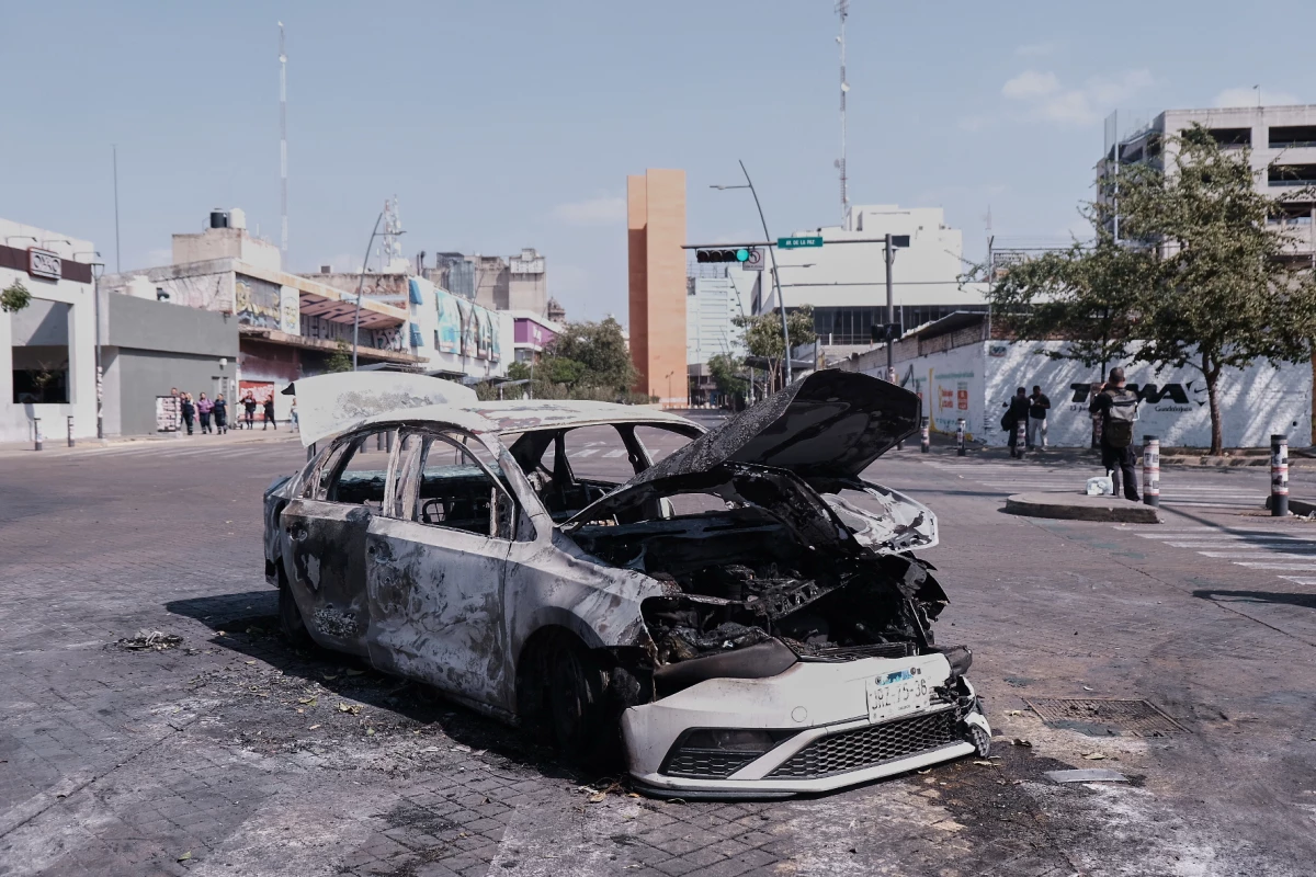 A vehicle sits charred after being set on fire, on a road in Guadalajara, Jalisco state, Mexico, Sunday, Feb. 22, 2026, after the death of the leader of the Jalisco New Generation Cartel, Nemesio Rubén Oseguera Cervantes, known as'El Mencho.'