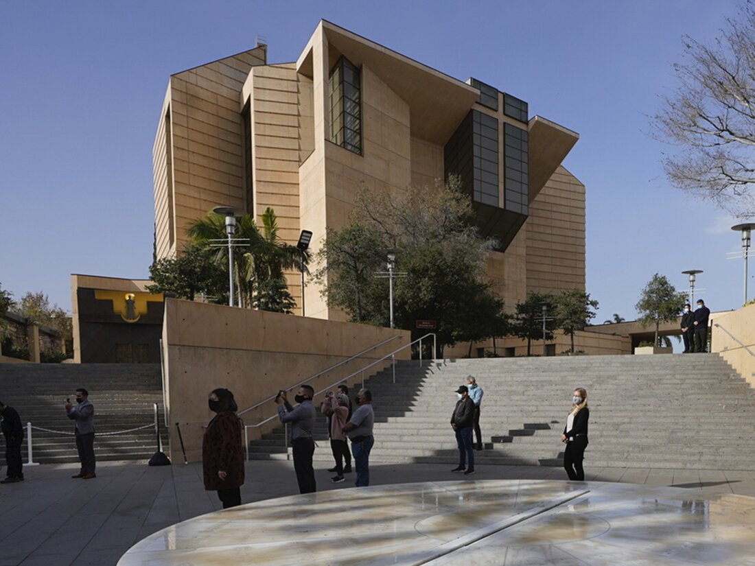 People attend a memorial service outside the Cathedral of Our Lady of Angels in Los Angeles, on Jan. 19, 2021.