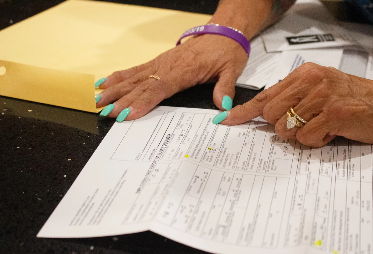 A workers compensation form describes Fred Jimenez' injury. It reads, 'Employee was pushed by a student and fell hitting his head.'