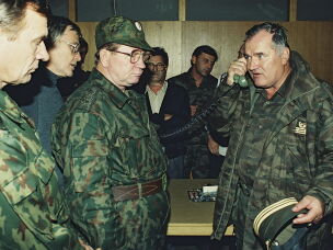 Bosnian Serb Gen. Ratko Mladic (right) talks on the phone next to Russian Army Gen. Vladimir Zurbenko (center) during the visit of a Russian Army delegation to the Bosnian town of Banja Luka in October 1995.