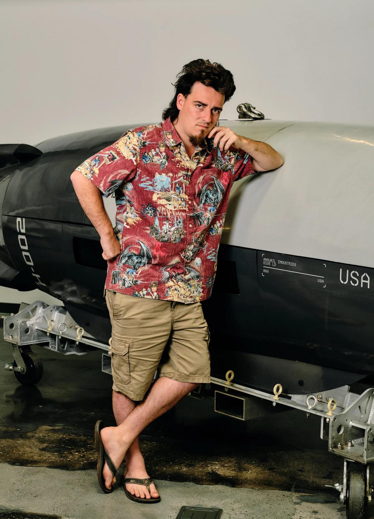 Palmer Luckey, 31, founder of Anduril Industries, stands in front of the Dive-LD, an autonomous underwater drone at company headquarters in Costa Mesa, Calif. Andruil recently won a U.S. Navy contract to build 200 of them annually.