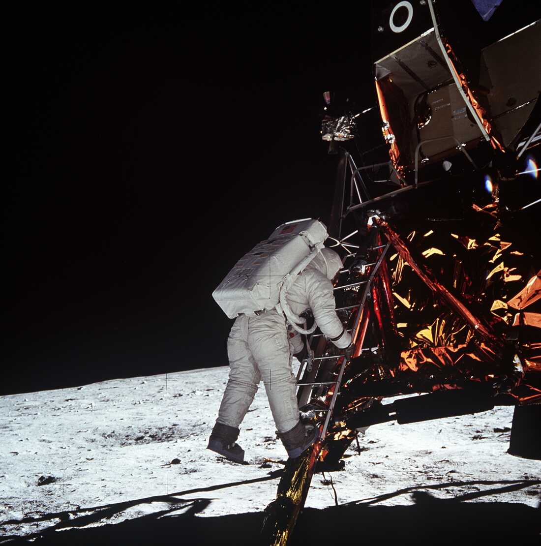 Astronaut Edwin E. Aldrin, Jr., lunar module pilot, descends the steps of the Lunar Module ladder July 20, 1969, as he prepares to walk on the Moon.
