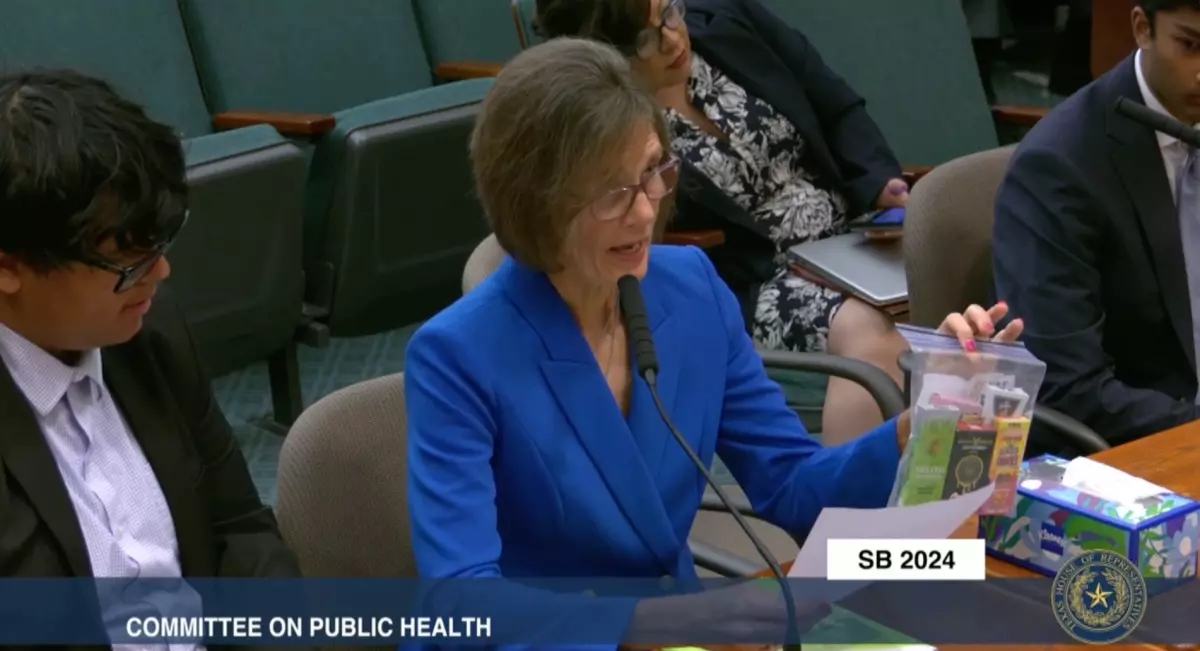 Pearland resident Christine Scruggs, testifying before the House Public Health Committee in May, holds up a ziplock bag containing cannabinoid vape packages. She said her son suffered psychiatric illness after becoming addicted to THC products.
