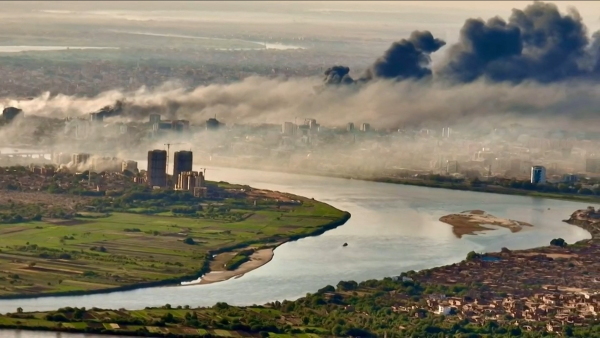 This video grab taken from AFPTV video footage on April 19, 2023, shows an aerial view of black smoke covering the sky above the capital Khartoum.