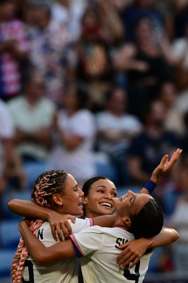 U.S. forward Trinity Rodman (L) and Mallory Swanson (R) celebrate after Sophia Smith scored in the 95th minute during the women's semifinal match Tuesday against Germany to advance to the gold medal game at the Paris Olympic Games.