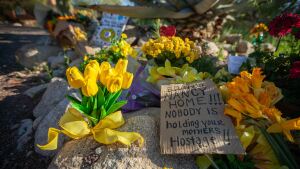 A piece of cardboard reads "Bring Nancy Home!!! Nobody is holding your mothers hostage!!" outside of Nancy Guthrie's home on Feb. 25, 2026 in Catalina Foothills, Ariz.