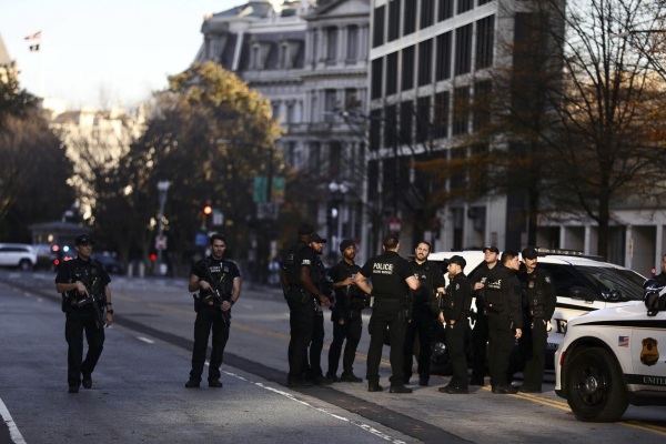 Law enforcement officials secure the scene after two National Guard members were shot in downtown Washington, D.C., on Wednesday.,