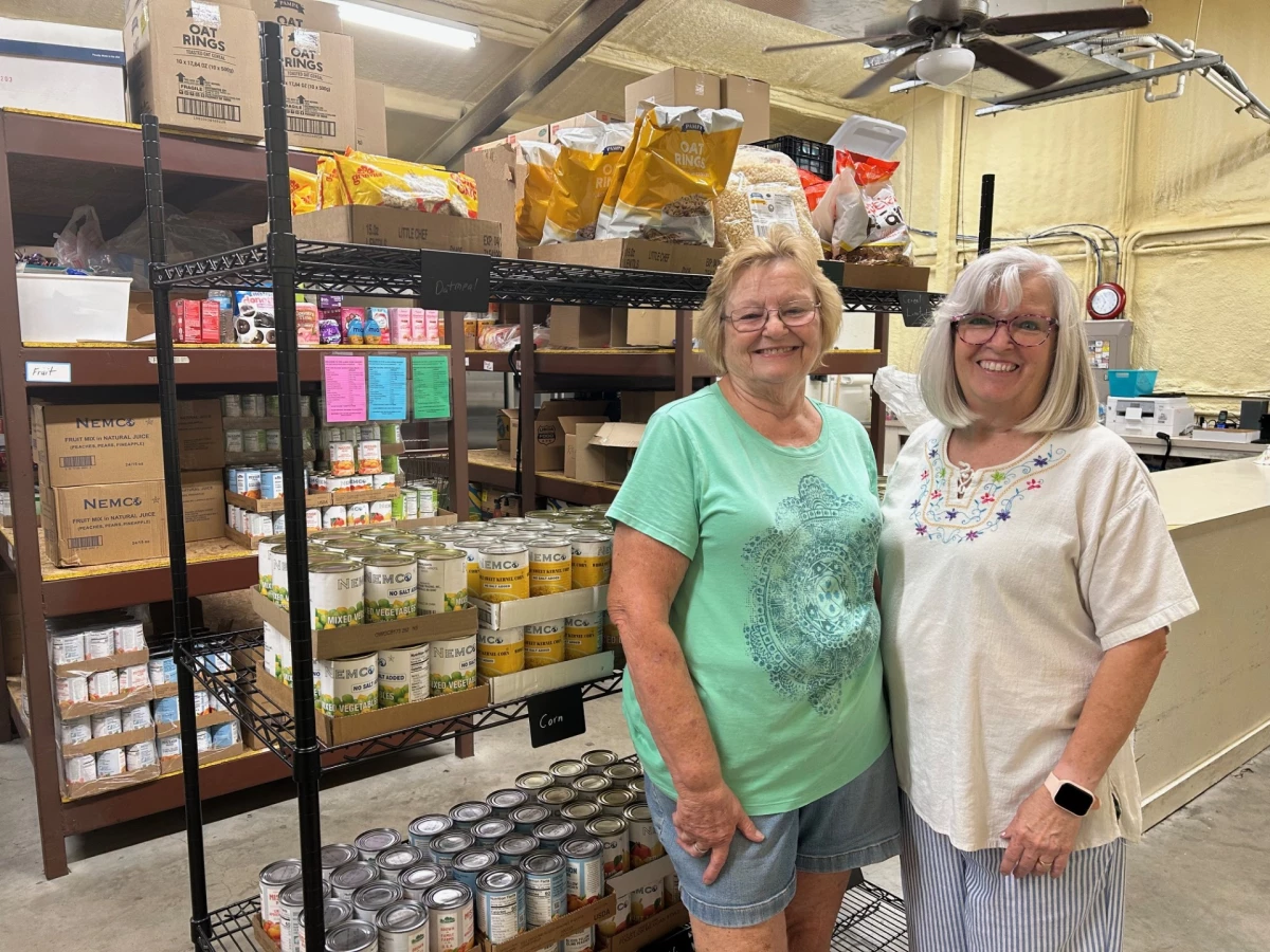 Mary Ann Edwards (L) and Chris Jones (R) have been volunteering at the Llano food pantry in central Texas for years. They describe seeing an uptick from 15-20 people each week to over a hundred clients every week.