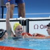 Ariarne Titmus of Team Australia celebrates after winning gold as Canada's Summer McIntosh (left) and USA's Katie Ledecky (right) win silver and bronze in the Women's 400m Freestyle Final on Saturday at Paris La Defense Arena in Nanterre, France.