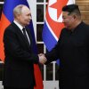 In this pool photograph distributed by the Russian state agency Sputnik, North Korea's leader, Kim Jong Un (right), and Russian President Vladimir Putin shake hands after a welcoming ceremony at Kim Il Sung Square in Pyongyang, North Korea, on June 19.