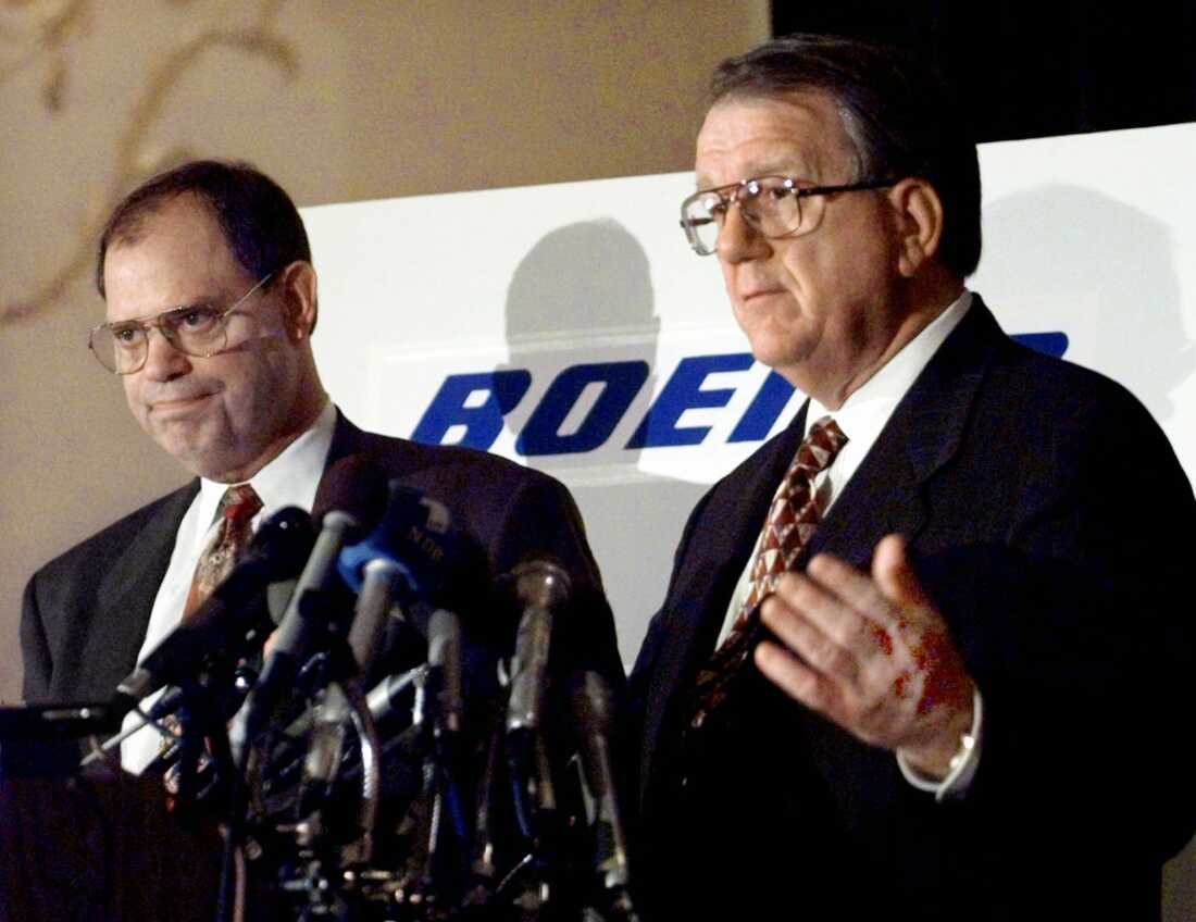 McDonnell Douglas CEO Harry Stonecipher, left, and Boeing CEO Phil Condit meet reporters in Washington on July 23, 1997, to discuss the European Union's approval of their companies' merger. 