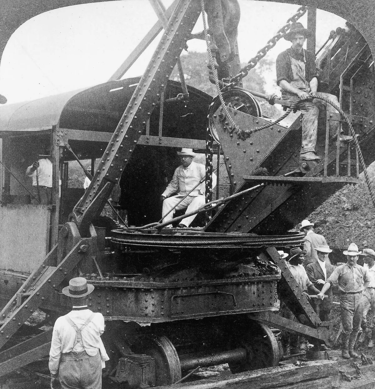 President Theodore Roosevelt (center) sits on a steam shovel at the Culebra Cut of the Panama Canal in November 1906.