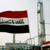 Iraqi flags flutter during the opening ceremony of a new oil refinery plant in the Shiite holy city of Najaf
