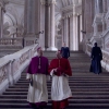 Cardinal O'Malley (Brían F. O'Byrne) confers with Cardinal Lawrence in Conclave.