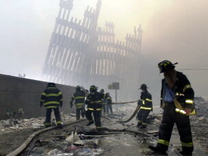 Firefighters work at the site of the destroyed World Trade Center in New York City on Sept. 11, 2001.