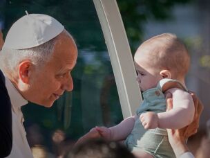 Pope Leo XIV greets a child upon arriving in the popemobile at Plaza de Cibeles for a Holy Mass and Corpus Christi procession in Madrid, Spain, Sunday, June 7, 2026, on the second day of his seven-day apostolic visit to mainland Spain and the Canary Islands.