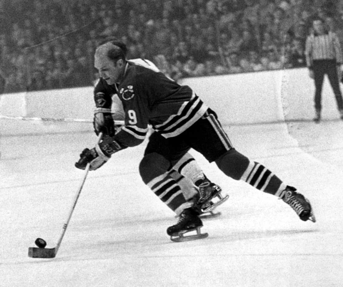 Bobby Hull of the Chicago Blackhawks skates down the ice with the puck during a hockey game against the Boston Bruins on Jan. 7, 1968. Hull would become one of the National Hockey League's 100 greatest players. His wife says repeated collisions during his Hall of Fame career led to his post-mortem diagnosis of CTE.