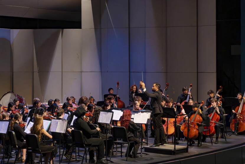 Serjoe Gutierrez directs his students during an orchestra performance.