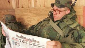 US soldier Sgt. John Hubbuch of Versailles, Ky., one of the members of NATO led-peacekeeping forces in Bosnia reads Stars and Stripes newspaper on Sunday Feb. 14, 1999. (AP Photo/Amel Emric, File)