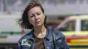 Viktoria Kitsenko poses for a portrait in front of Epicenter, the hardware superstore where she was working when it was hit with a Russian missile, killing 19 people in Kharkiv, Ukraine, on May 26.