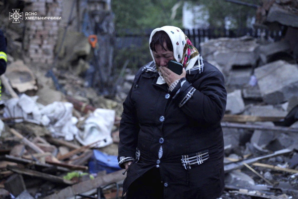 In this photo provided by the Ukrainian Emergency Service, a local resident cries standing amid the rubble of her house ruined after Russia's air attack in Khmelnytskyi region, Ukraine, Sunday, May 25, 2025.