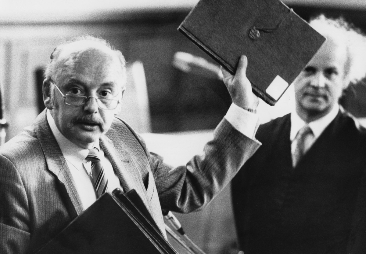 Konrad Kujau, left, who became well known for fabricating Hitler's diaries, presents copies of the faked diaries in a civil court house on August 29, 1984, in Hamburg, northern Germany.