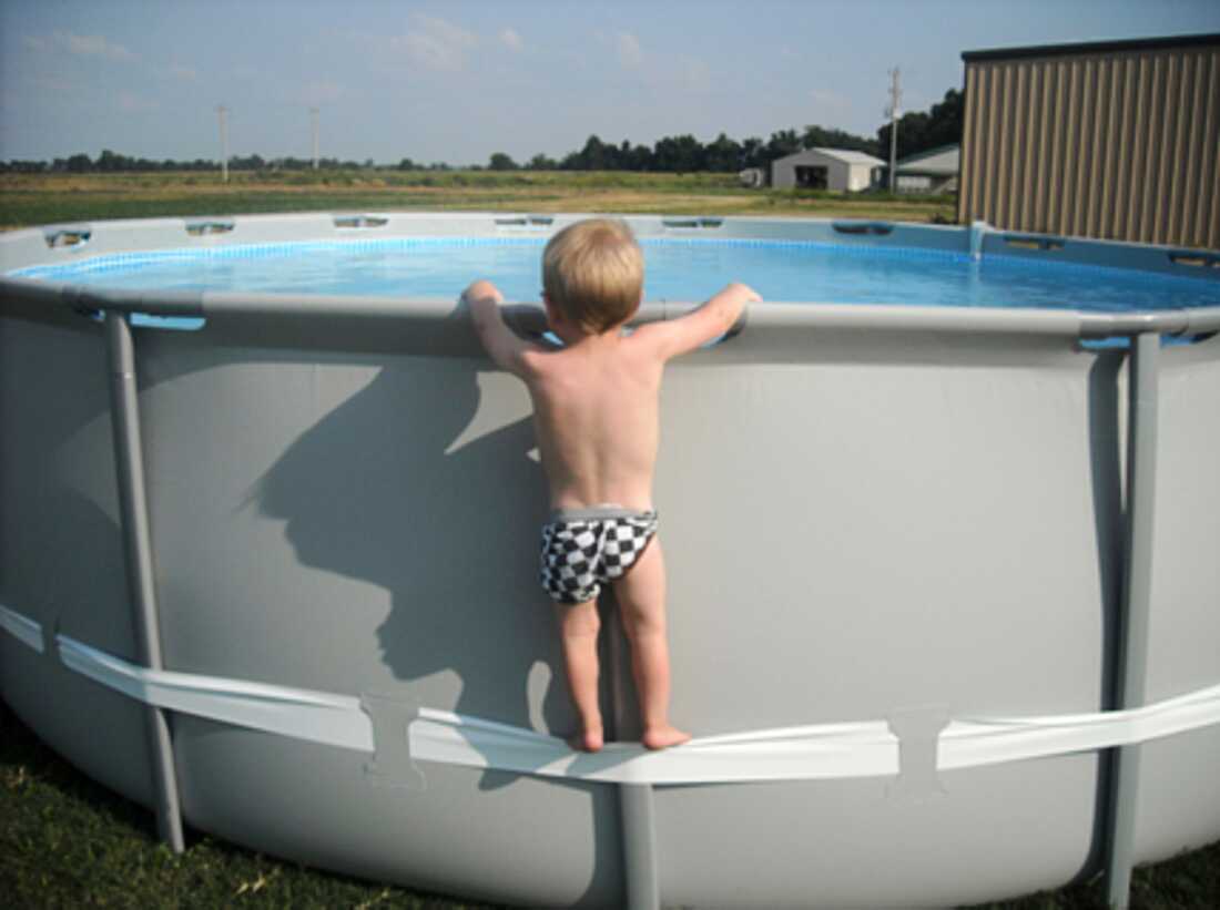 In this undated image provided by the CPSC, a child uses the compression strap to stand on above-ground pool. (CPSC via AP)