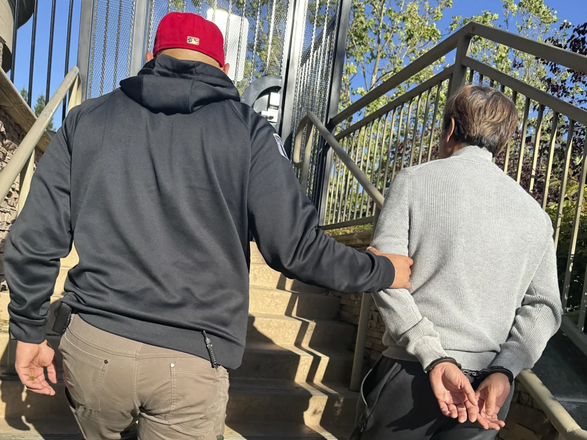 Tuen Kit Lee is led away in handcuffs on Tuesday, May 28, 2024, in Danville, Calif. The fugitive dubbed the 'bad breath rapist' was arrested in the San Francisco Bay area more than 16 years after he fled following his conviction for sexually assaulting a co-worker in Massachusetts, authorities said this week.