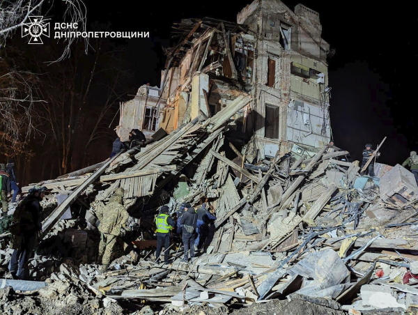 Firefighters work on a site of an apartment building destroyed by a Russian attack in Kryvyi Rih, Ukraine.  