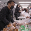 Jose Centeno hands food to LAUSD student Jesus Sanchez at Hollenbeck Middle School on Friday, Jan. 10.