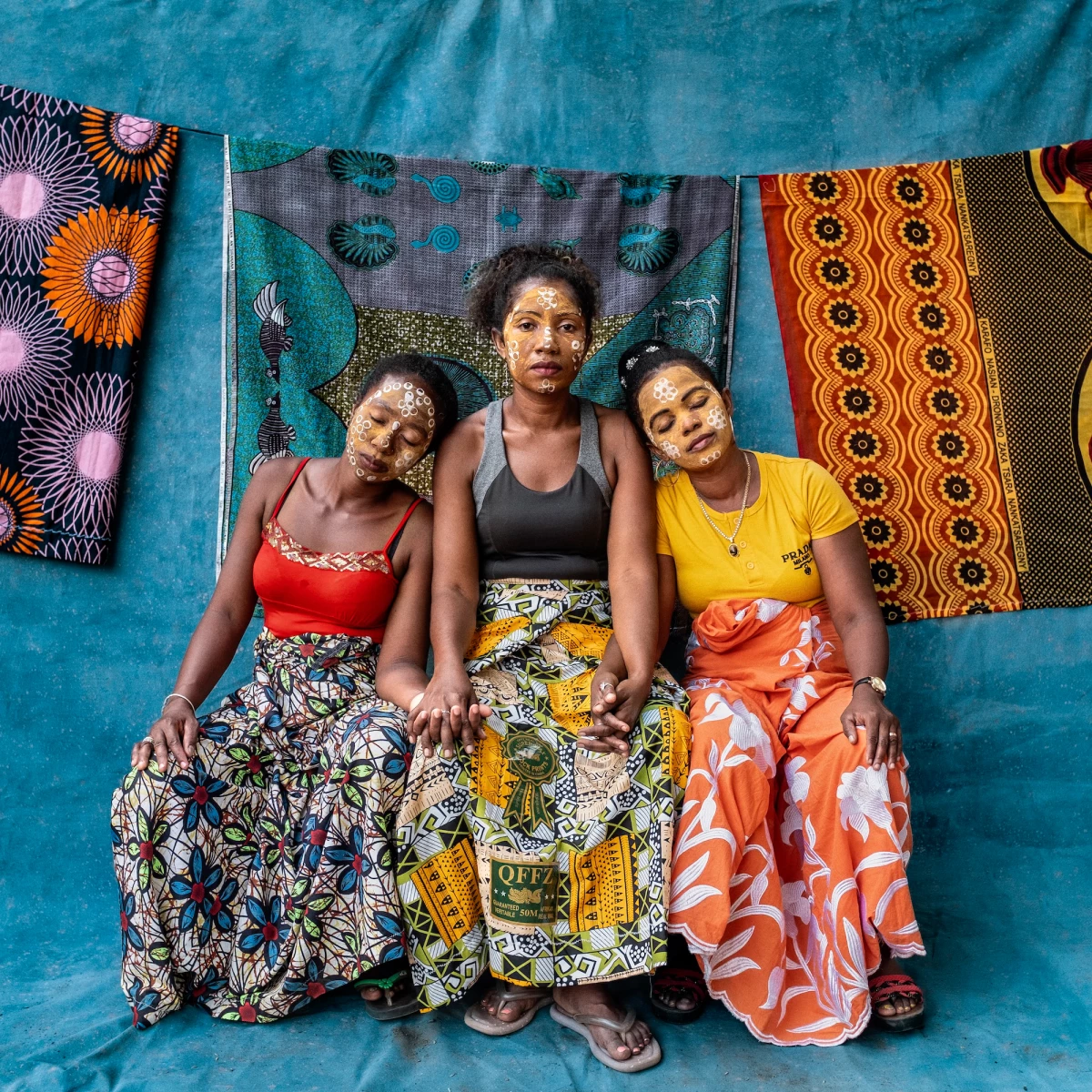 The photo exhibit Sahy Rano, on display at the Photoville Festival in Brooklyn, New York, this summer, draws its title from a Malagasay phrase translated in a wall label as  'someone who is not afraid to dive into the water, even if there is a strong current.' The photographer wants to bring attention to female genital schistosomiasis, a neglected tropical disease caused by a waterborne parasitic infection, whose symptoms can be stigmatizing because they resemble symptoms of sexually transmitted diseases. From left to right: former patients Rahama Abdallah, Sylvia Razanaparana and Suzanie Yolandrie. They were photographed in September 2024 in the district of Ambanja in Northern Madagascar.