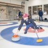 Ted Hallock delivers a rock during a curling game at the Potomac Curling Club in Laurel, Md. Curling clubs often see a boost in interest following the Winter Olympics.