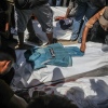 Palestinians mourn the death of journalists who were killed in an Israeli strike on Nasser Hospital in Khan Younis. Gaza's civil defense agency said five journalists were among at least 20 other people killed in the attack.