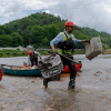 Hayden Cheek cleans debris out of the North Toe River in Western North Carolina.