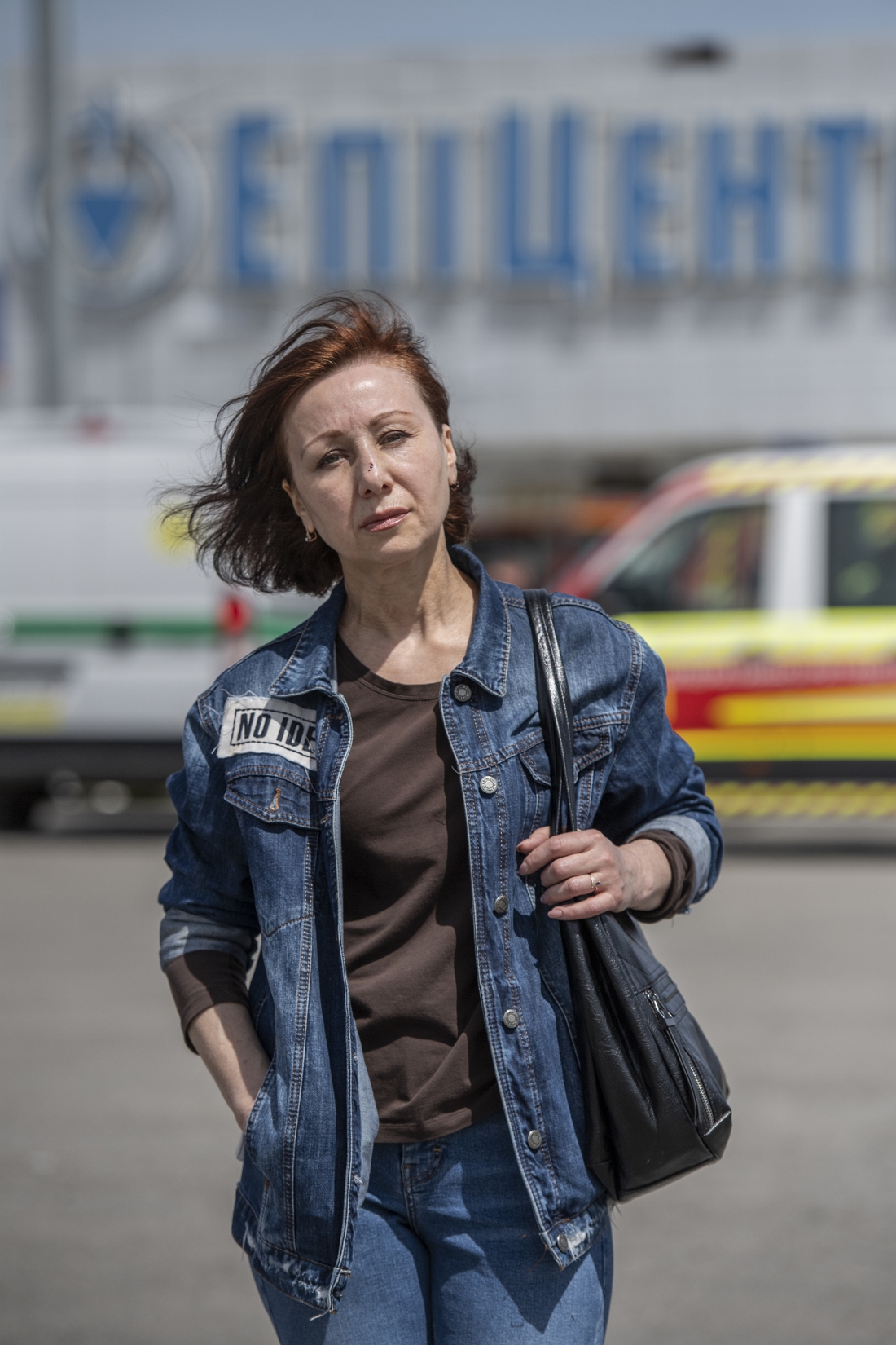 Viktoria Kitsenko poses for a portrait in front of Epicenter, the hardware superstore where she was working when it was hit with a Russian missile, killing 19 people in Kharkiv, Ukraine, on May 26.